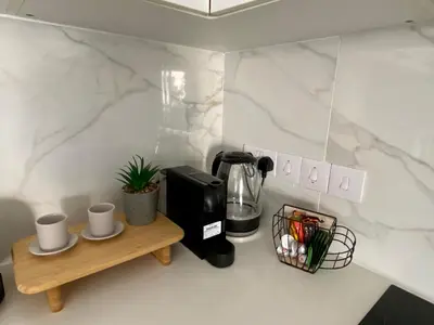a coffeemaker and coffee maker on a table in a kitchen at Stylish Apt near UNIC Medical School & EUC in Engomi
