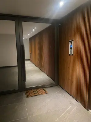 a hallway with a sliding glass door in a building at Stylish Apt near UNIC Medical School & EUC in Engomi