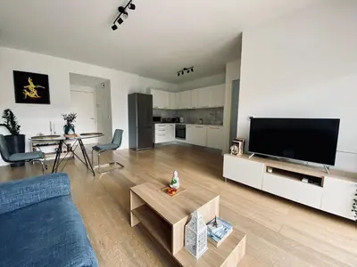 a living room with a couch and a tv at Stylish Apt near UNIC Medical School & EUC in Engomi