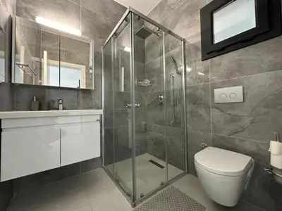 a bathroom with a shower and a toilet and a sink at Marcellus in Larnaka