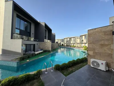 an image of a swimming pool in a building at Kervansaray Comfort in Ayii Trimithias