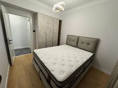 a bedroom with a bed in the corner of a room at Kervansaray Comfort in Ayii Trimithias