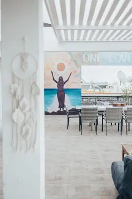a mural in a restaurant with a woman on the wall at One Love One World Ayia Napa Square Hostel in Ayia Napa