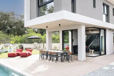 a patio with a table and chairs next to a pool at Black Diamond Villas Protaras in Protaras