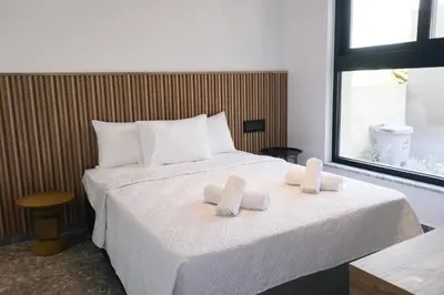 a bedroom with a bed with two folded towels on it at Black Diamond Villas Protaras in Protaras