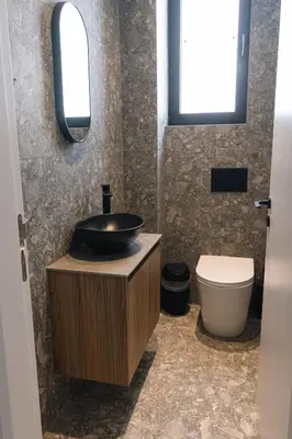 a bathroom with a sink and a toilet at Black Diamond Villas Protaras in Protaras
