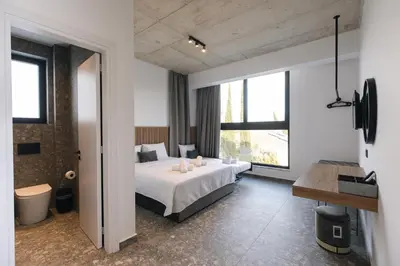 a bedroom with a bed and a large window at Black Diamond Villas Protaras in Protaras