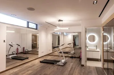 a gym with treadmills and exercise equipment in a room at Villa JoJo Seafront in Ayia Napa
