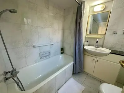a bathroom with a tub and a sink and a toilet at 2 bedrooms flat near center in Engomi