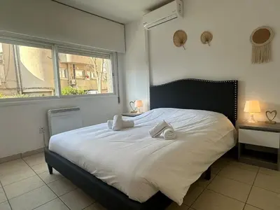 a bedroom with a white bed with two pillows on it at 2 bedrooms flat near center in Engomi