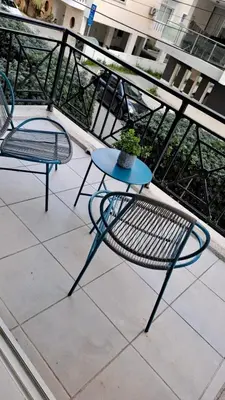 two chairs and a table on a balcony at 2 bedrooms flat near center in Engomi