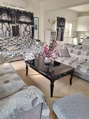 a living room with couches and a coffee table at ANDRIA'S luxury family studio near Casino limassol in Limassol