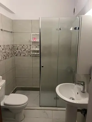 a bathroom with a shower and a toilet and a sink at Tiffany 11 Finikoudes in Larnaka
