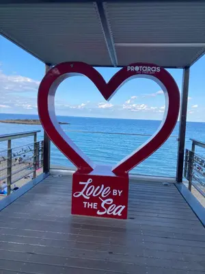 a heart shaped sign on a pier with the ocean at MANDARIN Villa in Paralimni