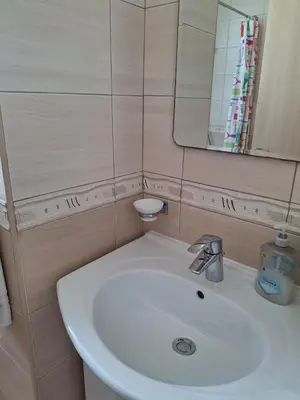 a bathroom with a white sink and a mirror at MANDARIN Villa in Paralimni