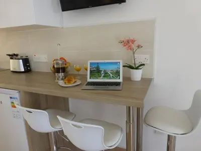 a kitchen with a counter with a laptop on it at STAY Paradise Sands Studio in Ayia Napa