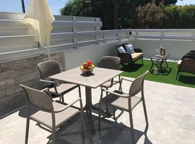 a table and chairs with a bowl of fruit on a patio at STAY Paradise Sands Studio in Ayia Napa