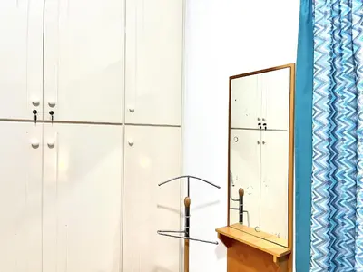 a dressing room with white cabinets and a mirror at STAY ALKYONI Villa in Protaras