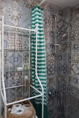 a bathroom with a shower with a green towel at Cozy Holiday Apartment with Balcony in Pyla