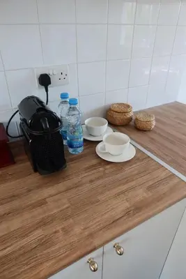 a counter with two bowls and water bottles on it at Cozy Holiday Apartment with Balcony in Pyla