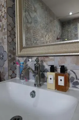 a bathroom sink with a mirror and some soap bottles at Cozy Holiday Apartment with Balcony in Pyla