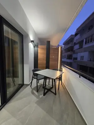 a table and a chair on a balcony at Zen City Suites in Larnaka
