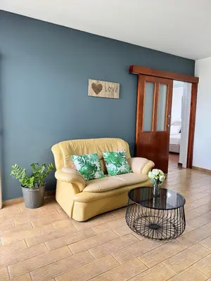 a living room with a couch and a table at Gold Feather 2Bedroom Center Location and Pool in Ayia Napa