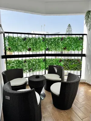 a patio with chairs and tables and a large window at Gold Feather 2Bedroom Center Location and Pool in Ayia Napa
