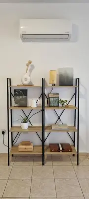 a shelf with various items on it in a room at The Cozy Home Stay in Larnaca in Larnaka