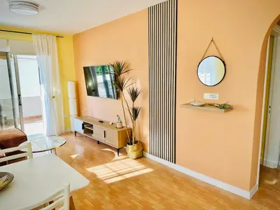 a living room with a table and a mirror at Sunny Days Apartment in Paralimni
