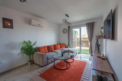 a living room with a couch and a table at Mythical Sands Resort and Spa in Paralimni