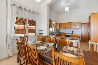 a kitchen and dining room with a table and chairs at Villa Thea, Luxury Cliff Sea View in Pissouri