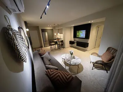 a living room with a couch and a television at Ficus Suite 001 in Voroklini