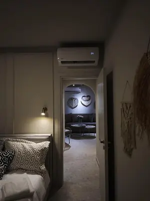 a bedroom with a bed and a living room at Ficus Suite 001 in Voroklini