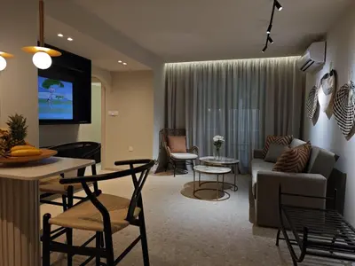 a living room with a couch and a table at Ficus Suite 001 in Voroklini