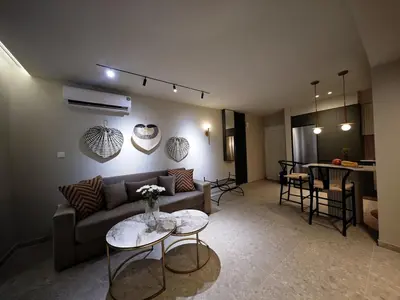 a living room with a couch and a table at Ficus Suite 001 in Voroklini