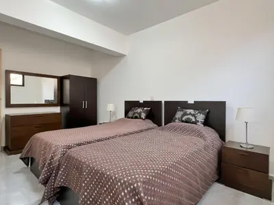 a bedroom with a large bed and a mirror at Villa Aris in Ayios Theodhoros