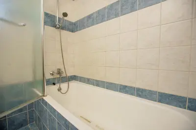 a bathroom with a bath tub with a shower at STAY Villa Kangaroo in Protaras