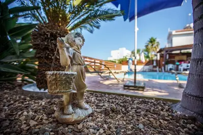 a statue of a girl with a basket on the ground at STAY Villa Kangaroo in Protaras