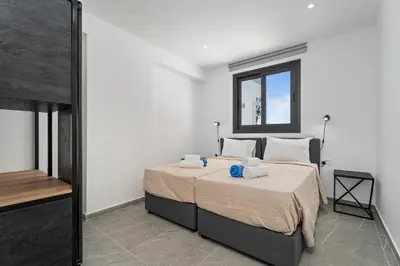 a bedroom with a bed and a window at PANATHEON - Luxury 1 & 2 bdr bungalows 300 meters from sandy beach! in Ayia Napa