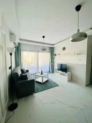 a living room with a couch and a table at Caesar Resort Apartments Marcellus 51 in Iskele