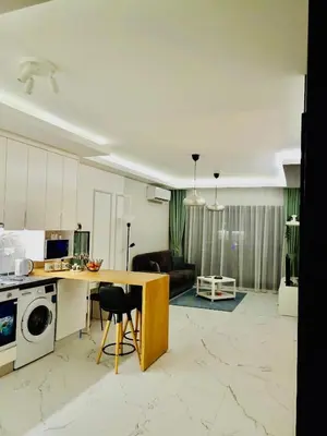 a kitchen and living room with a table and a microwave at Caesar Resort Apartments Marcellus 51 in Iskele