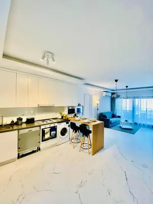a large kitchen with white cabinets and a counter at Caesar Resort Apartments Marcellus 51 in Iskele