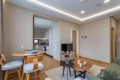 a living room with a table and chairs at Pantio Living Residence in Meneou