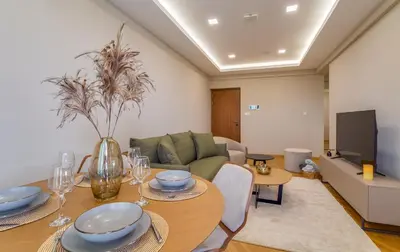 a living room with a table and a couch at Pantio Living Residence in Meneou