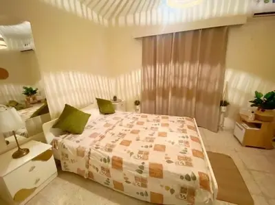 a bedroom with a large bed with green pillows at Holiday home in Kapparis in Paralimni