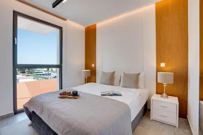 a bedroom with a bed and a large window at Sea View Central Deluxe GAIA 302 in Larnaka