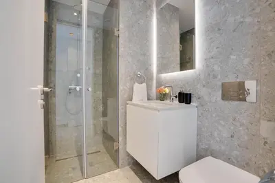 a bathroom with a shower and a toilet and a sink at Sea View Central Deluxe GAIA 302 in Larnaka