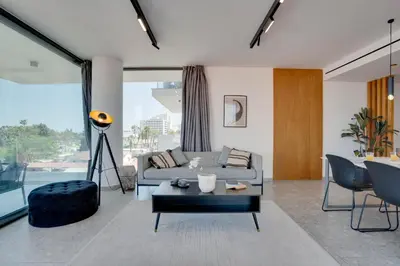 a living room with a couch and a table at Sea View Central Deluxe GAIA 302 in Larnaka