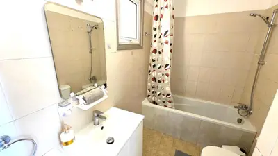 a bathroom with a sink and a toilet and a shower at Stylish 2BR Apartment with Balcony, Wifi & Pool in Larnaka